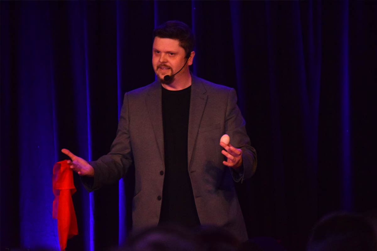 Mark Roberts performing a stage magic show