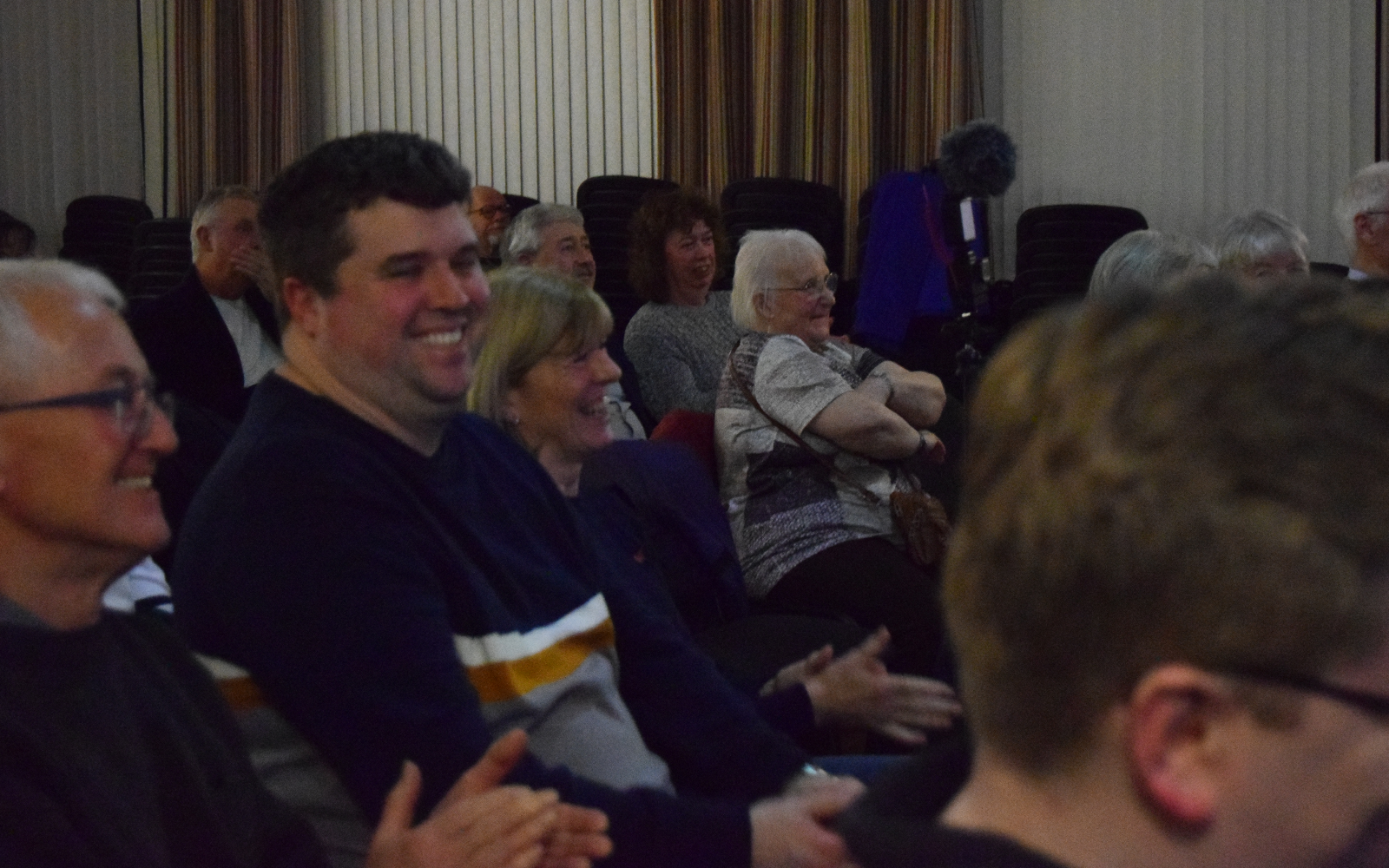 Audience reacting during a Mark Roberts live magic show